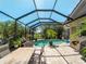 Enjoy a spacious outdoor dining area with a screened pool, perfect for entertaining and relaxation at 11982 Granite Woods Loop, Venice, FL 34292