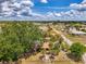 Aerial view of property showcasing the surrounding neighborhood and mature trees at 12018 Saragossa Ln, North Port, FL 34287