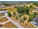 Aerial view of property showcasing spacious lot with mature trees near the highway at 12018 Saragossa Ln, North Port, FL 34287
