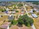 Aerial view of a charming neighborhood, showcasing a spacious lot with mature trees at 12018 Saragossa Ln, North Port, FL 34287
