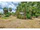 Back yard with mature trees and a fenced in garden at 12018 Saragossa Ln, North Port, FL 34287