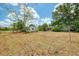 View of the back yard showcasing the mature trees and an outbuilding at 12018 Saragossa Ln, North Port, FL 34287