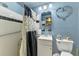 Cozy bathroom showcasing a shower with updated fixtures, a modern vanity, and a stylish blue color scheme at 12018 Saragossa Ln, North Port, FL 34287