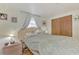 Cozy bedroom features comfortable bedding, a wood floor, and a convenient bedside table at 12018 Saragossa Ln, North Port, FL 34287