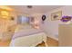 A bedroom featuring wood floors, lavender bedding, and side tables with lamps at 12018 Saragossa Ln, North Port, FL 34287