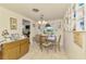 Cozy dining room features a classic wooden table and chairs with a window view at 12018 Saragossa Ln, North Port, FL 34287