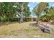 Well maintained front yard with mature trees providing ample shade at 12018 Saragossa Ln, North Port, FL 34287