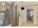 Modern kitchen has stainless steel fridge, and views into dining area at 12018 Saragossa Ln, North Port, FL 34287