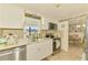 A kitchen featuring tile flooring, white cabinets, and stainless steel appliances at 12018 Saragossa Ln, North Port, FL 34287