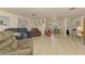 Spacious living room with tile flooring, and views into the dining room at 12018 Saragossa Ln, North Port, FL 34287