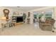 Open living room features tile flooring, and a view into the sunroom at 12018 Saragossa Ln, North Port, FL 34287