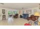 Bright living room featuring neutral tile flooring and a sunroom at 12018 Saragossa Ln, North Port, FL 34287