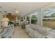 Inviting sunroom with a ceiling fan and large windows, ideal for relaxing and taking in the view at 12018 Saragossa Ln, North Port, FL 34287