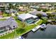 Home aerial view showcasing a pool, dock, waterfront access, and well-kept landscaping in a serene neighborhood at 1306 Osprey Dr, Punta Gorda, FL 33950
