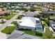 Aerial view of a property with a screened-in pool, well-manicured lawn and boat dock on a waterfront canal at 1306 Osprey Dr, Punta Gorda, FL 33950