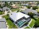 Aerial view of backyard featuring a screened-in lanai and pool, surrounded by well-maintained landscaping at 1306 Osprey Dr, Punta Gorda, FL 33950