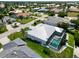 Beautiful aerial view of a home with a screened-in pool and lush landscaping in a waterfront community at 1306 Osprey Dr, Punta Gorda, FL 33950
