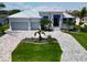 Stunning aerial view of the single-story home, landscaped yard, and circular driveway at 1306 Osprey Dr, Punta Gorda, FL 33950