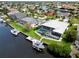 Waterfront home featuring a screened lanai, private pool, dock, and boat, all surrounded by lush landscaping at 1306 Osprey Dr, Punta Gorda, FL 33950