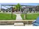 Inviting backyard showcasing lush landscaping, stone pathways, and a screened-in lanai for outdoor enjoyment at 1306 Osprey Dr, Punta Gorda, FL 33950