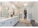 Elegant bathroom with dual sinks, chandelier, and walk-in closet provides luxury and convenience at 1306 Osprey Dr, Punta Gorda, FL 33950