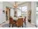Bright dining room with large glass doors and water view offers a serene and scenic space at 1306 Osprey Dr, Punta Gorda, FL 33950