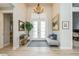Grand foyer with tiled floors, double doors, and a charming seating area at 1306 Osprey Dr, Punta Gorda, FL 33950