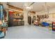 Organized garage with ample storage cabinets, epoxy flooring, and space for parking vehicles and motorcycles at 1306 Osprey Dr, Punta Gorda, FL 33950