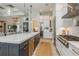 Modern kitchen with a large island, stainless steel appliances, and stylish pendant lights at 1306 Osprey Dr, Punta Gorda, FL 33950