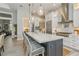 Modern kitchen with a large island, stainless steel appliances, and stylish pendant lights at 1306 Osprey Dr, Punta Gorda, FL 33950