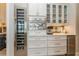 Gourmet kitchen with a wine fridge, built-in oven, custom cabinetry, and elegant countertops at 1306 Osprey Dr, Punta Gorda, FL 33950