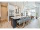 Modern kitchen with a large island, stainless steel appliances, pendant lighting, and an adjacent dining area at 1306 Osprey Dr, Punta Gorda, FL 33950