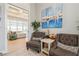 Stylish living area with tufted chairs, a nautical painting, and an open layout for comfortable living at 1306 Osprey Dr, Punta Gorda, FL 33950