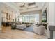 Bright, open living room with sectional sofa flows into kitchen with pendant lighting at 1306 Osprey Dr, Punta Gorda, FL 33950
