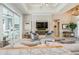 Cozy living space with modern decor, a sleek fireplace, and an open layout connecting to the kitchen at 1306 Osprey Dr, Punta Gorda, FL 33950