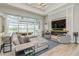 Stylish living area featuring a modern fireplace, large sliding doors, and an open connection to the dining area at 1306 Osprey Dr, Punta Gorda, FL 33950