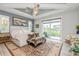 Serene main bedroom with tray ceilings, a decorative ceiling fan, and access to an outdoor seating area at 1306 Osprey Dr, Punta Gorda, FL 33950