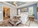 Spacious main bedroom with backyard views, elegant decor, and an adjoining bathroom at 1306 Osprey Dr, Punta Gorda, FL 33950