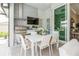 Alfresco dining area with modern stainless steel grill, hood, and outdoor kitchen, adjacent to the indoor living space at 1306 Osprey Dr, Punta Gorda, FL 33950