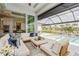 Inviting screened-in lanai with plush seating, opening to a sparkling pool, and offering stunning water views at 1306 Osprey Dr, Punta Gorda, FL 33950