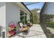 Cozy screened patio with wicker furniture, ideal for relaxation and enjoying the garden view at 1306 Osprey Dr, Punta Gorda, FL 33950