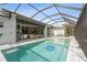 Large screened pool and spa overlooking the spacious outdoor living space with kitchen and comfortable seating at 1306 Osprey Dr, Punta Gorda, FL 33950