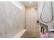 Modern shower with marble-like tile, a bench, and niche for storage, offering a spa-like experience at 1306 Osprey Dr, Punta Gorda, FL 33950
