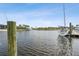 Beautiful waterfront view with boats docked along the canal and palm trees dotting the landscape at 1306 Osprey Dr, Punta Gorda, FL 33950