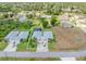 Aerial view of the home with a screened-in pool, showcasing the property's layout and surroundings at 1327 Hedgewood Cir, North Port, FL 34288