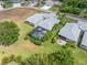 Aerial view of a backyard with a screened pool, complemented by lush landscaping and patio at 1327 Hedgewood Cir, North Port, FL 34288