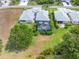 Aerial view of a home's backyard featuring a screened pool, manicured lawn, and mature trees at 1327 Hedgewood Cir, North Port, FL 34288