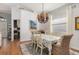 Cozy dining area with wood floors and an elegant chandelier, perfect for Gathering meals at 1327 Hedgewood Cir, North Port, FL 34288