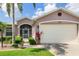 Charming home with a well-maintained lawn, mature landscaping, and a two-car garage at 1327 Hedgewood Cir, North Port, FL 34288