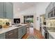 Kitchen with stainless dishwasher features a view of the outdoor pool and patio area at 1327 Hedgewood Cir, North Port, FL 34288